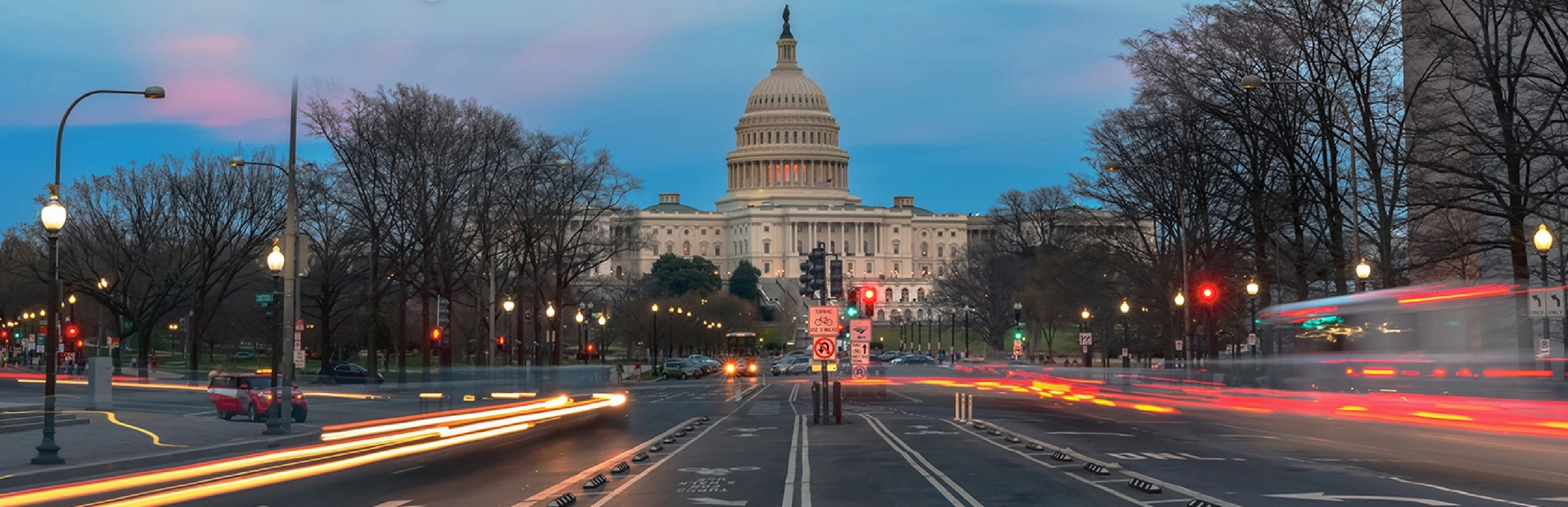 Capitol building with transportation at dusk